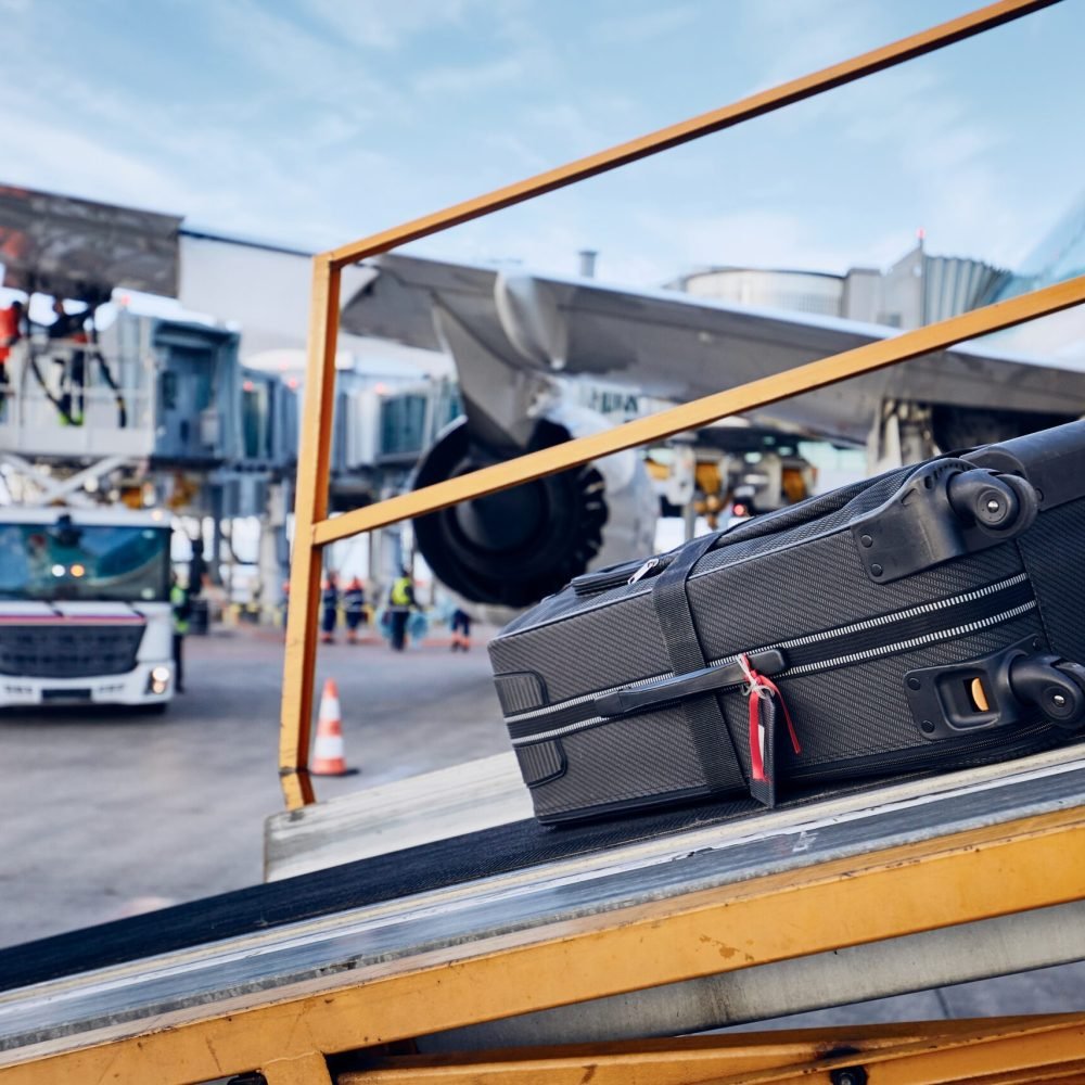 Preparations before flight. Loading luggage into airplane against refueling of airplane at airport. Travel and industry concepts.